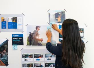 employee sticking a post-it on the wall