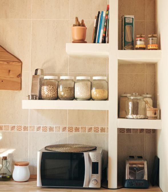 kitchen countertop and shelves with microwave and toaster