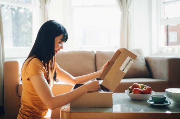 woman opening box